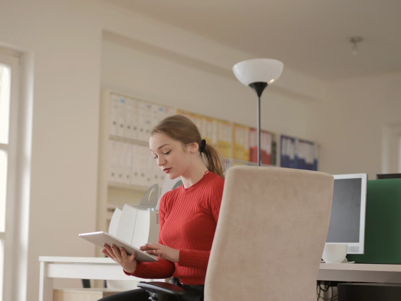 A Holded customer going through the books at her desk